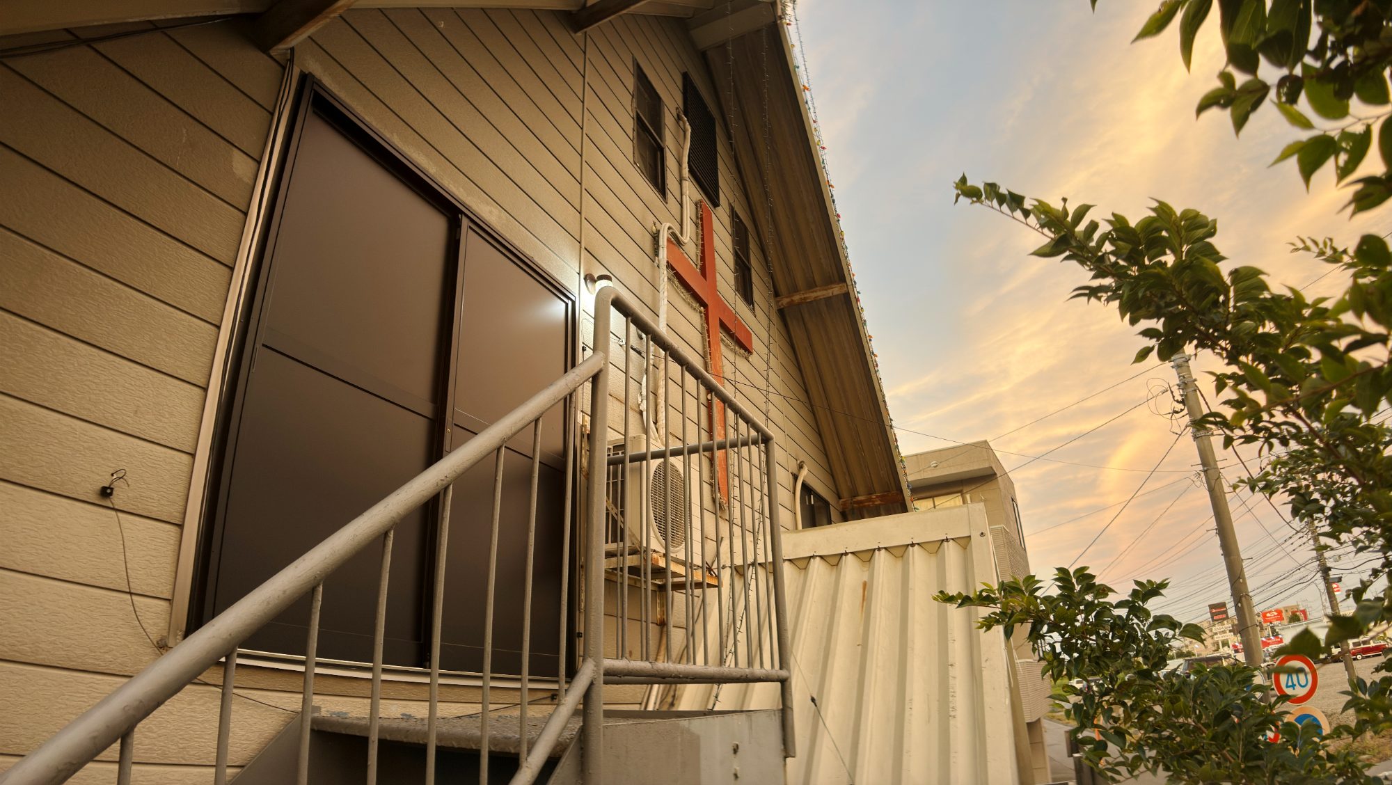An outdoor staircase on a white building at dusk
