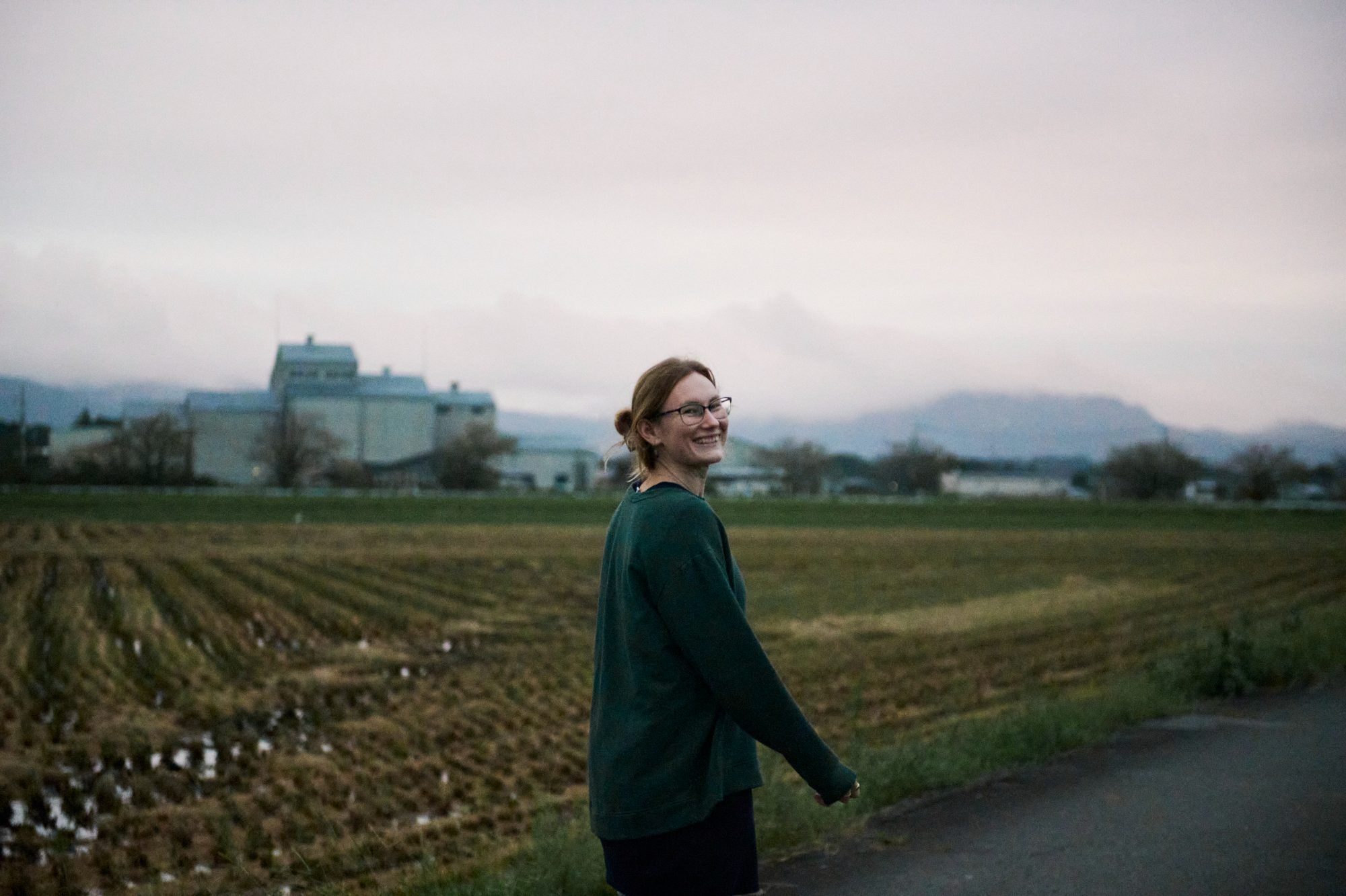 Walking a country road past harvested rice fields with Mount Tsukuba on the horizon