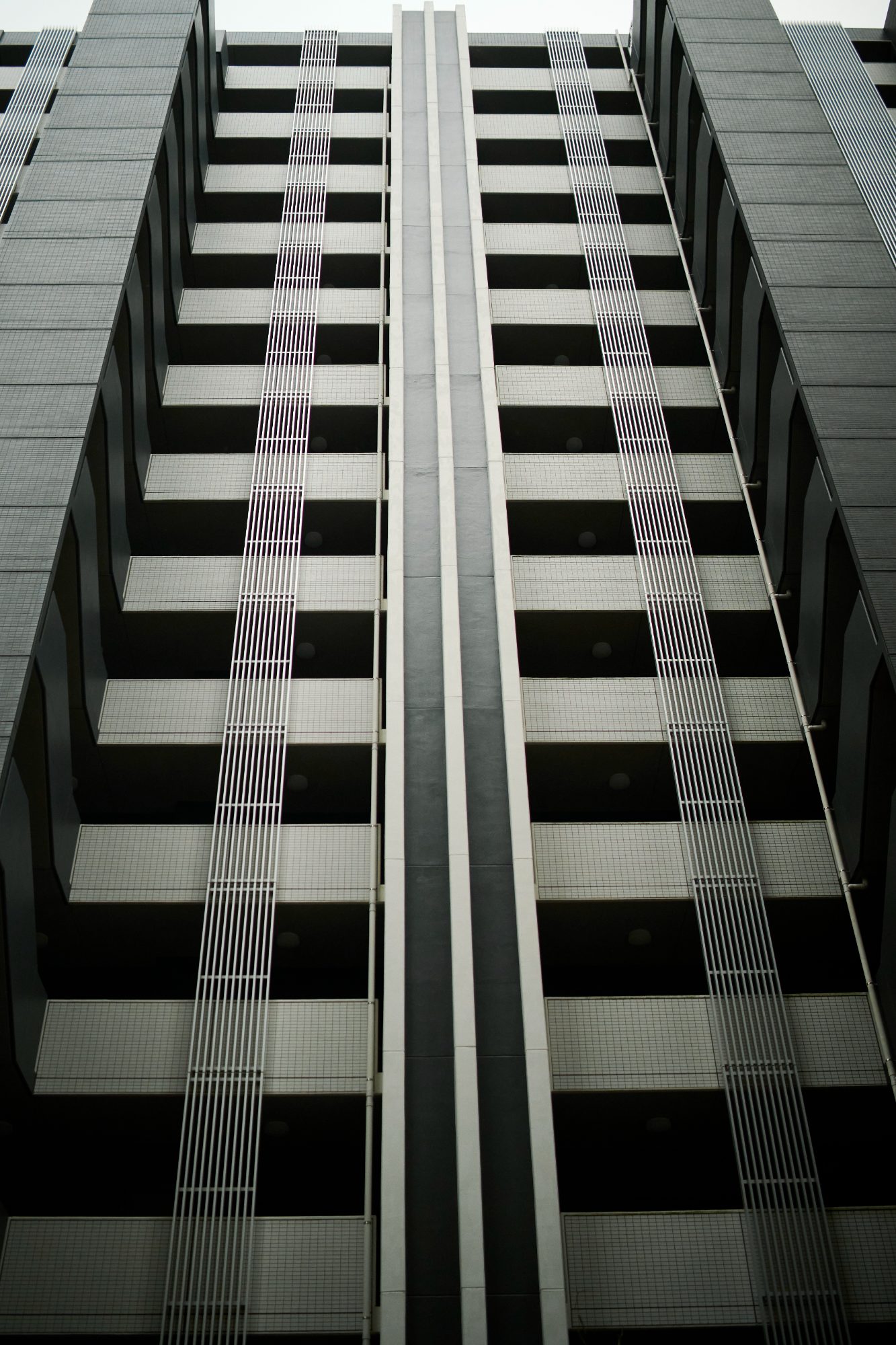 Looking straight up the face of a tall apartment building
