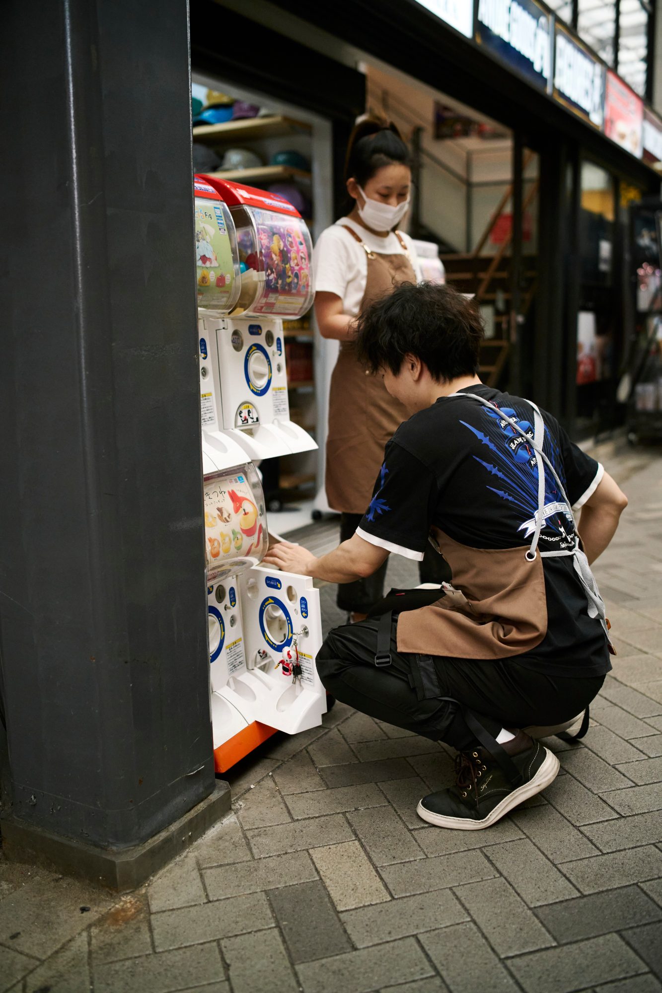 Shopkeepers arranging goods outside a storefront