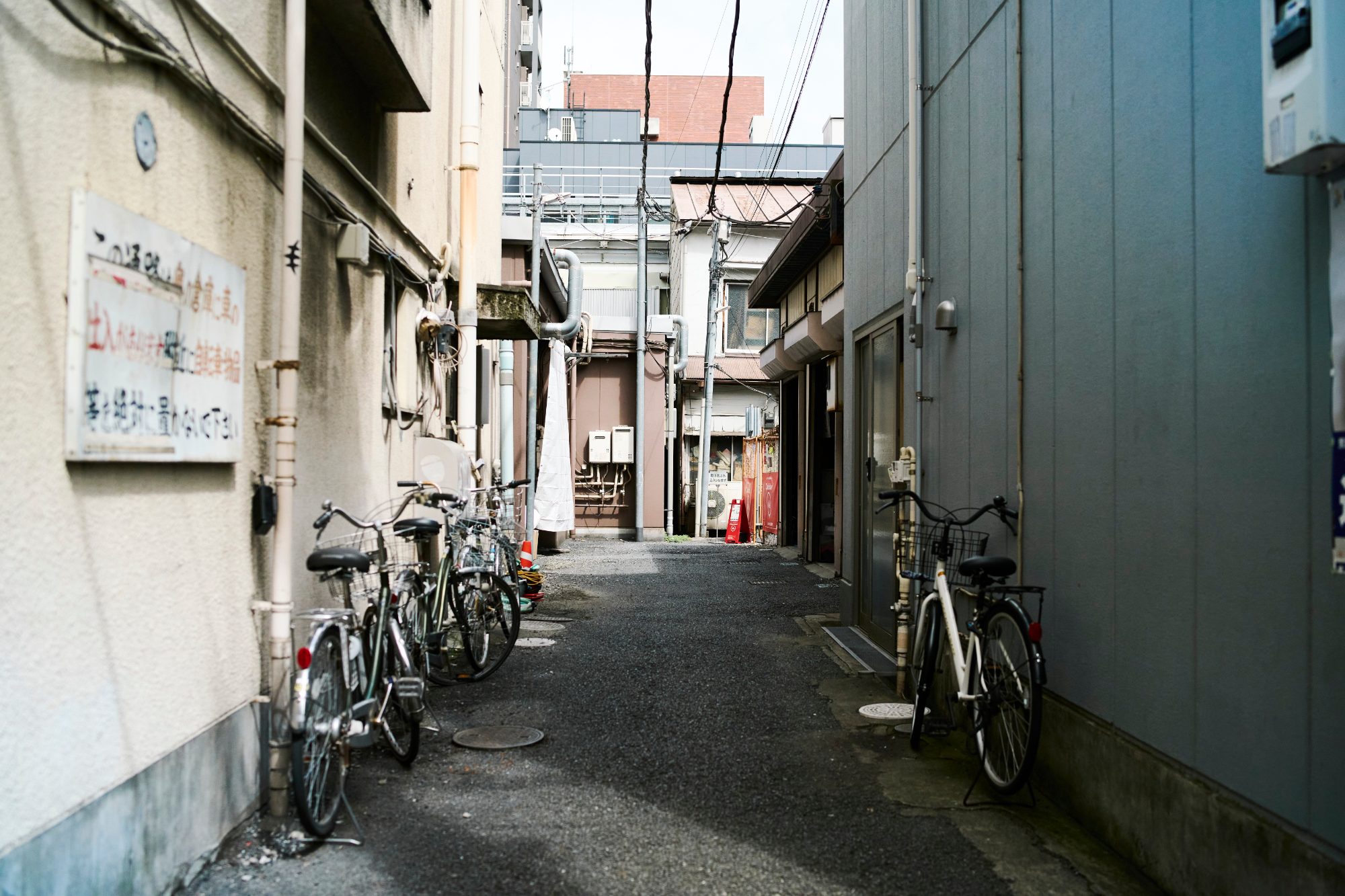 Bicycles parked along a narrow residential alley