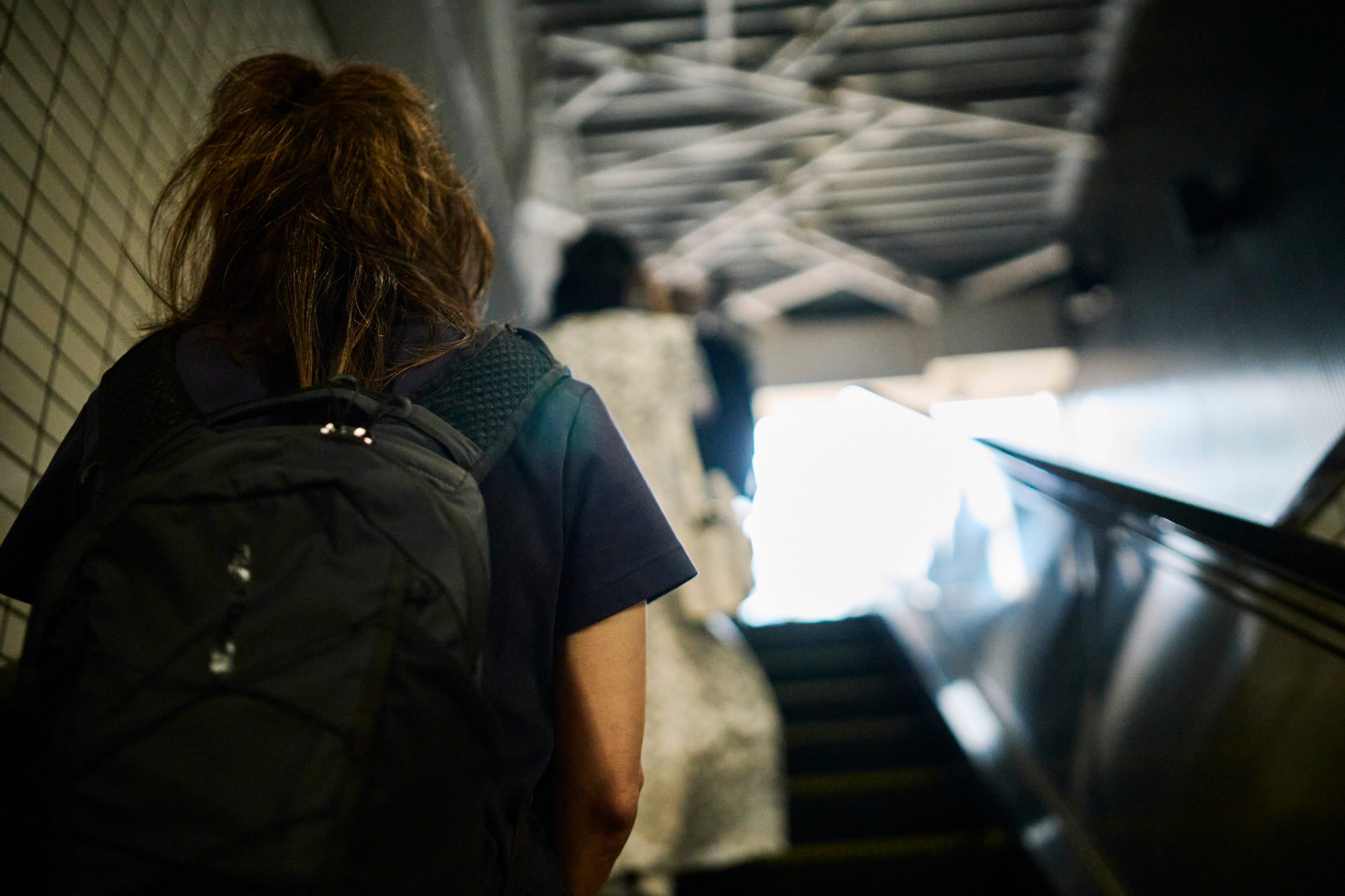 Riding an escalator up toward daylight