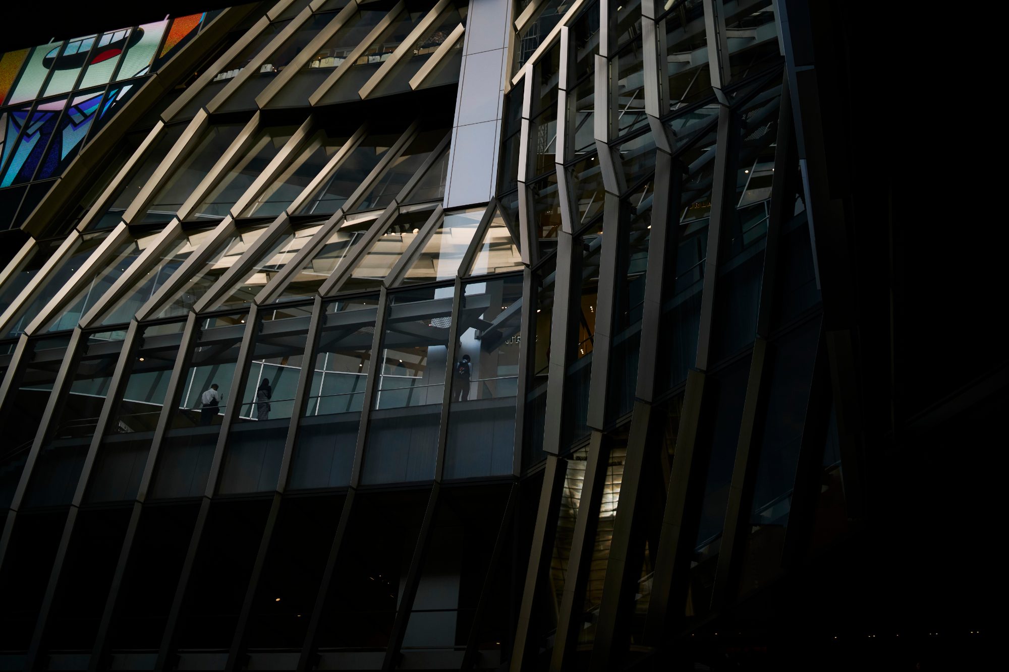 The dark ribbed facade of a glass building