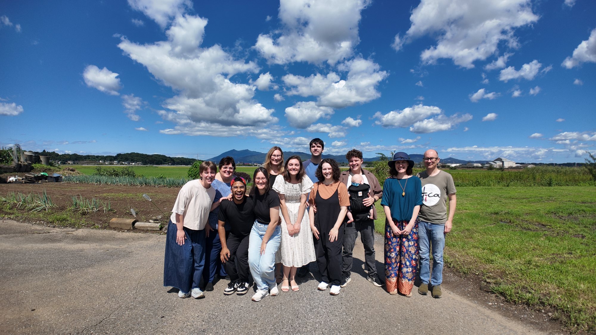 The team on a country road in Tsukuba, fields and mountains behind