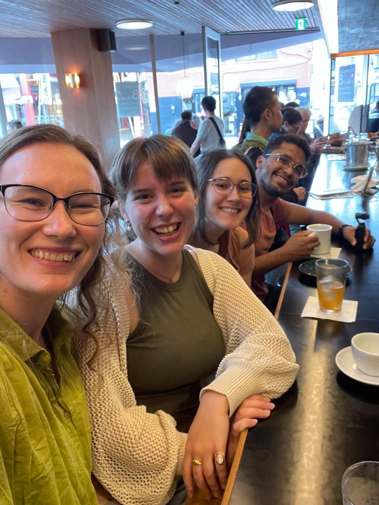 Friends smiling around a café table
