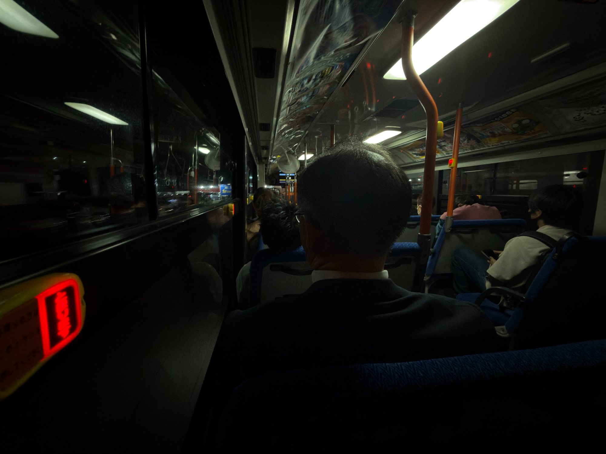 A dark bus interior at night