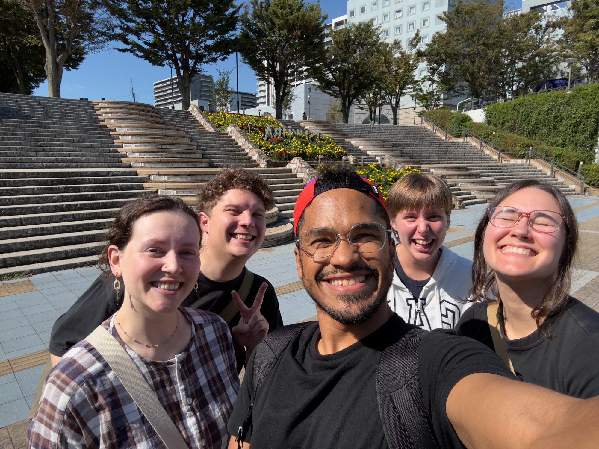 The five of us in a selfie on the Tsukuba Center steps, flowers and blue sky behind